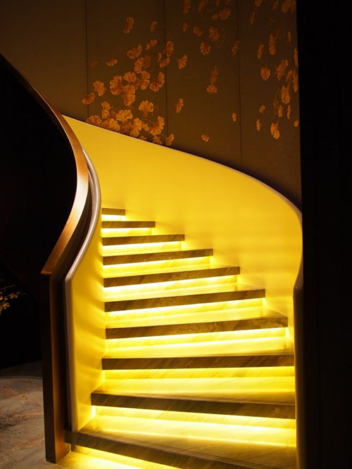 While gold-flecked Italian marble makes the staircases, embroidered suzhou silk lines the walls. Photo by Waldorf Astoria Beijing