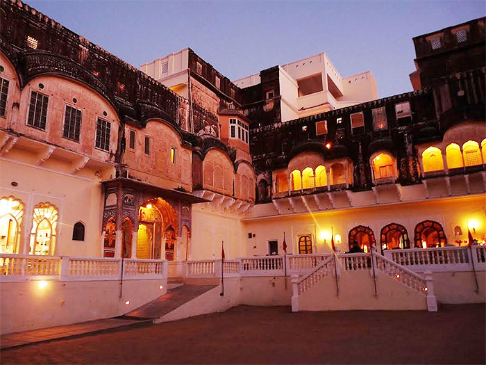 The lighted façade of the Mandawa fort in the evening is imposing in its grandeur, paying homage to the past but encapsulating today’s comforts 