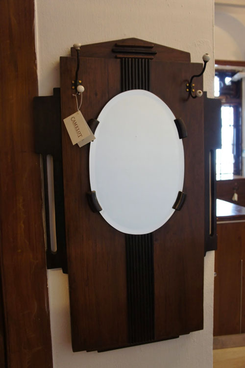 IF LUXE COULD KILL | Admiring yourself got a new dimension with this art deco mirror, complete with coathooks, from Camelot