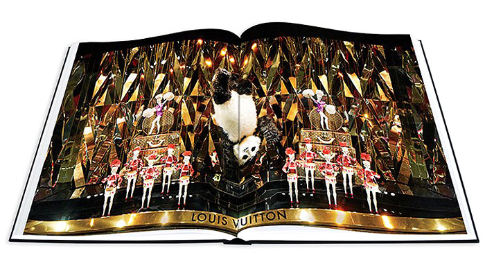 VUITTON VANITY | The 168-page art series highlights windows filled with roller coasters, circus performances and golden dinosaurs built around the label's offerings