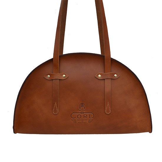 CORD | The hemisphere shaped bag is handcrafted in harness leather with antique finish hardware and a