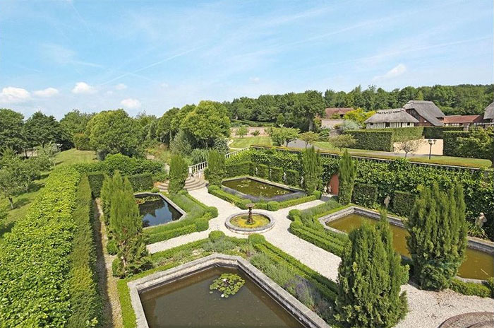 Lush gardens surround the entire property, beginning within the horseshoe of the main house and extending southward, comprising of mature herbaceous borders and a topiary knot garden