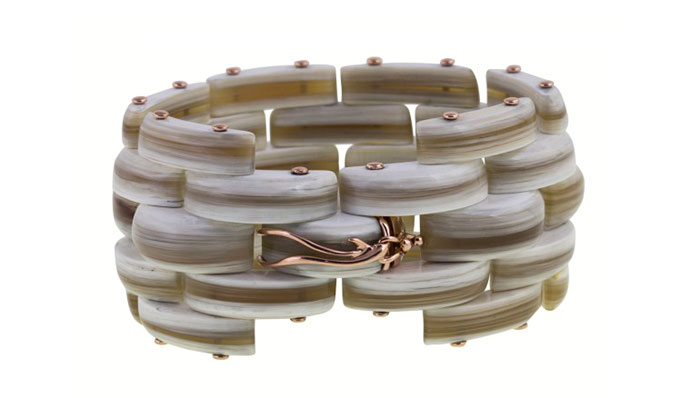 18 k gold bracelet featuring volcanic rock, petrified wood, and naturally striated Zebu horn, priced $9,500
