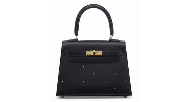 A rare black calf box leather mini Kelly 20 with gold hardware & studs. Hermès, 1994. Sold for: €14,375 on 9 November 2016